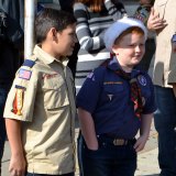 Local scouts watch the tree go up downtown.